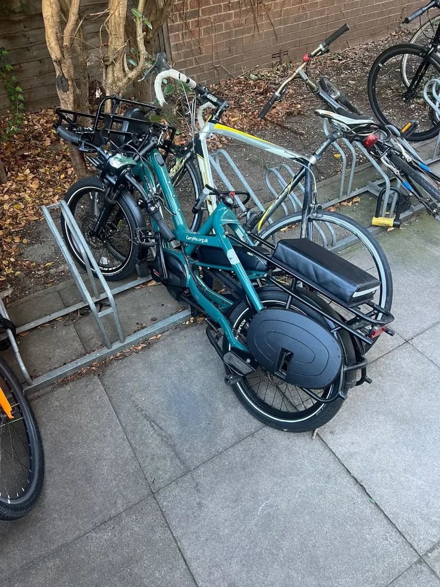 The Tern HSD on a cycle rack, unlocked, with its saddle pulled out